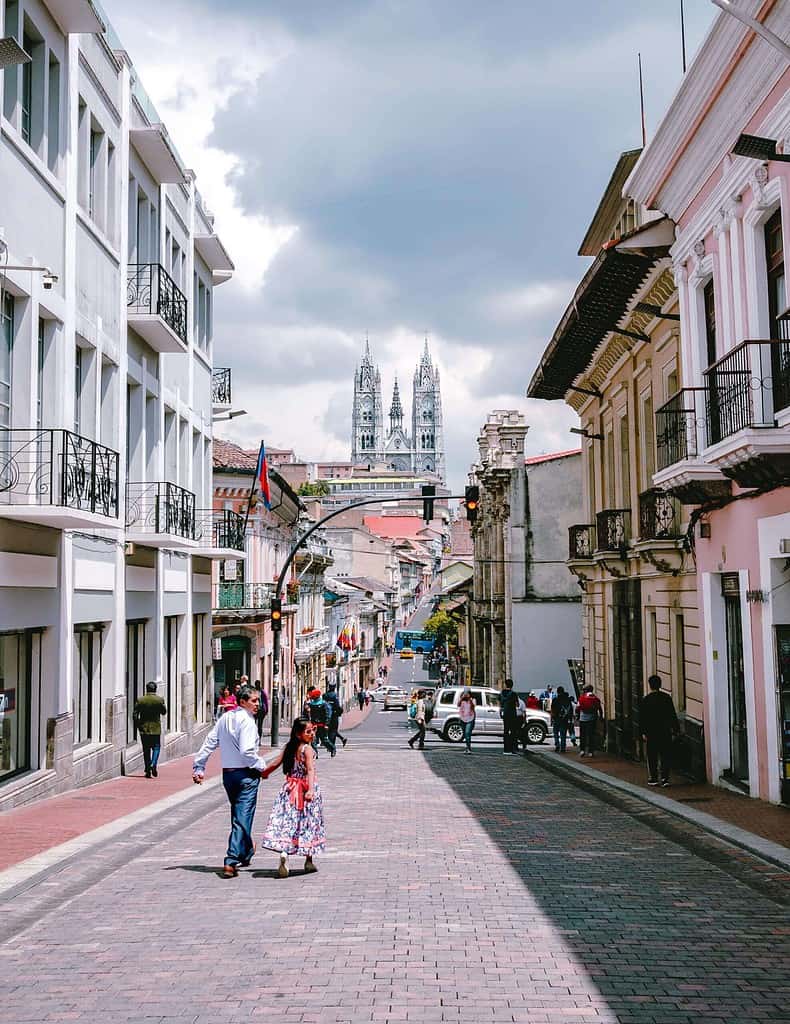 Quito Historic Centre - street with people walking and church in background